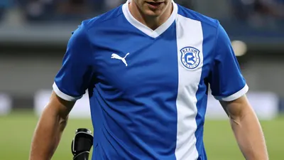 A photorealistic image of an anonymous KFUM Oslo player, aged 25-30, wearing a blue and white jersey with a white collar...
